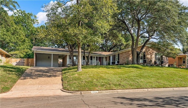 2901 Woodland Dr, Waco, TX 76710 - single story home with an attached carport, fence, an attached garage, concrete driveway, and a front lawn