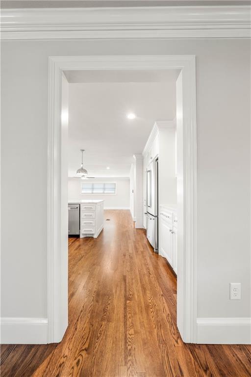 2901 Woodland Dr, Waco, TX 76710 - hallway with crown molding, baseboards, and wood finished floors