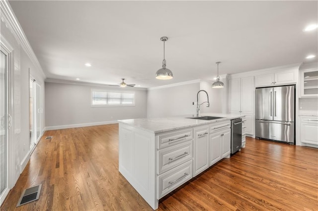 2901 Woodland Dr, Waco, TX 76710 - kitchen featuring visible vents, ornamental molding, stainless steel appliances, and a sink
