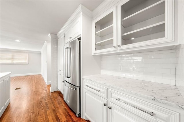 2901 Woodland Dr, Waco, TX 76710 - kitchen with tasteful backsplash, white cabinetry, high quality fridge, and glass insert cabinets