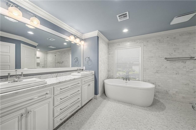 2901 Woodland Dr, Waco, TX 76710 - bathroom with visible vents, double vanity, a freestanding tub, a sink, and crown molding