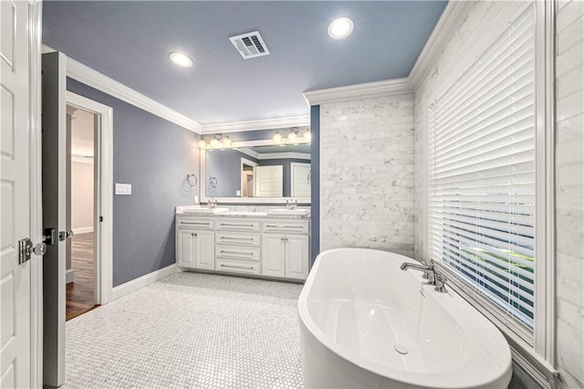 2901 Woodland Dr, Waco, TX 76710 - full bathroom featuring visible vents, double vanity, a freestanding tub, a sink, and crown molding
