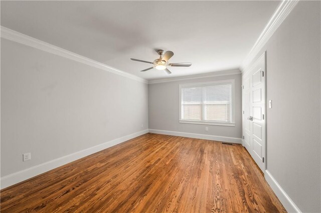 2901 Woodland Dr, Waco, TX 76710 - spare room with crown molding, wood finished floors, and baseboards