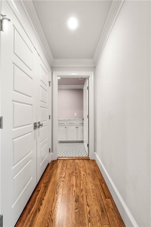 2901 Woodland Dr, Waco, TX 76710 - corridor featuring baseboards, wood finished floors, and ornamental molding