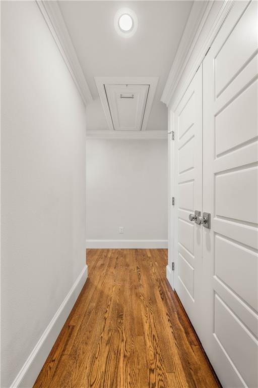 2901 Woodland Dr, Waco, TX 76710 - hallway featuring attic access, wood finished floors, baseboards, and ornamental molding