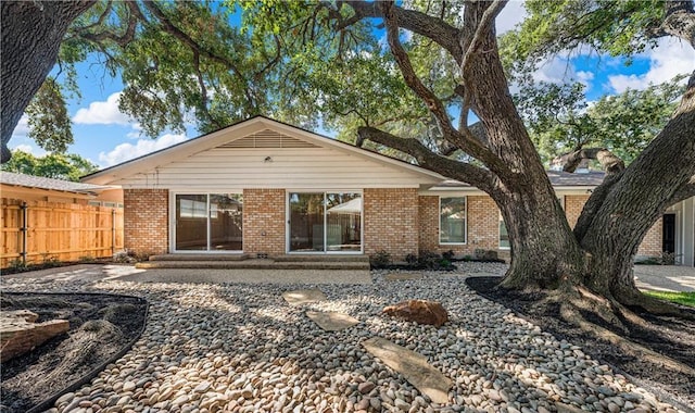 2901 Woodland Dr, Waco, TX 76710 - rear view of property with entry steps, fence, and brick siding