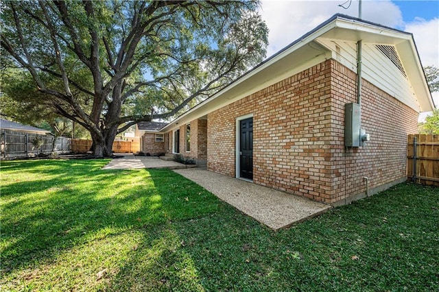 2901 Woodland Dr, Waco, TX 76710 - exterior space with a yard, a patio, brick siding, and a fenced backyard