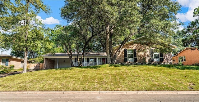 2901 Woodland Dr, Waco, TX 76710 - view of front of house featuring a carport, a front lawn, and fence