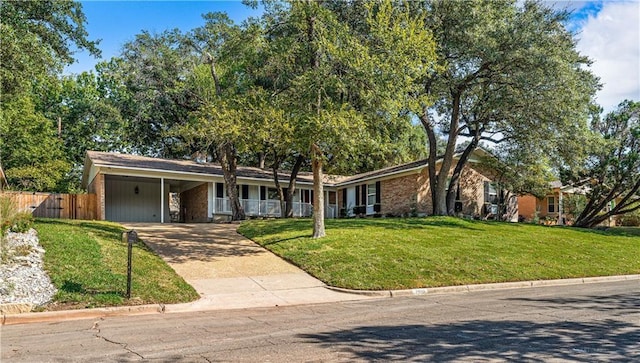 2901 Woodland Dr, Waco, TX 76710 - single story home with a carport, concrete driveway, fence, and a front yard