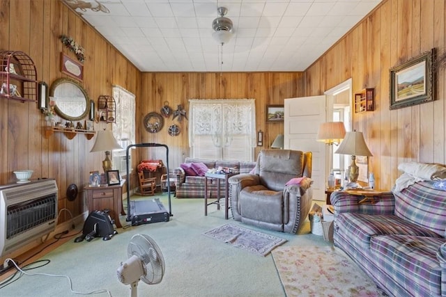 living room with heating unit and carpet
