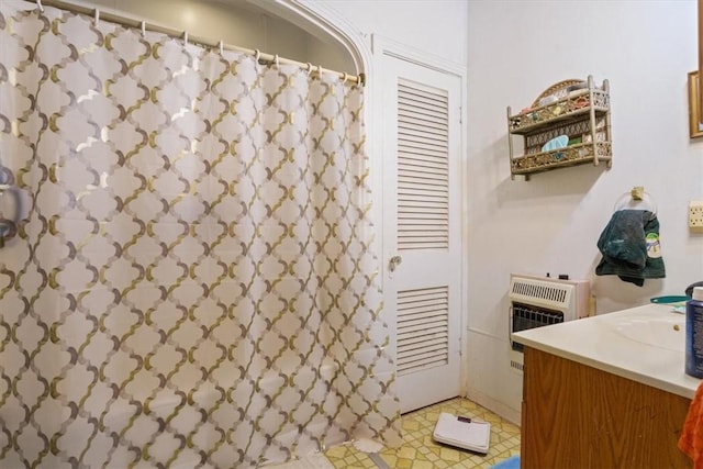bathroom with a shower with curtain, heating unit, vanity, and tile patterned flooring