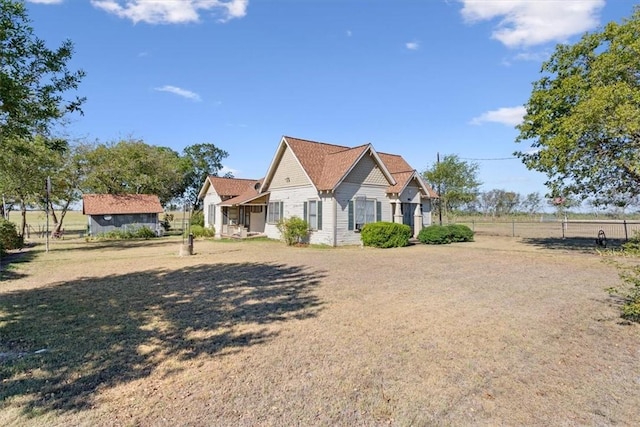 view of front of property featuring an outbuilding and fence