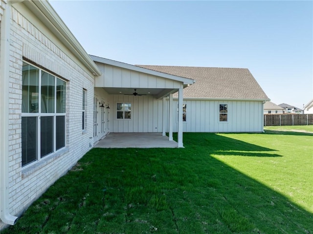 view of yard with fence, a ceiling fan, and a patio area