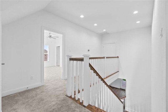 corridor featuring an upstairs landing, recessed lighting, carpet flooring, baseboards, and vaulted ceiling