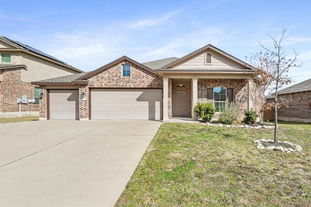 2820 Keathley Dr, Lorena, TX 76655 - view of front of house featuring a front yard, driveway, roof with shingles, a garage, and brick siding