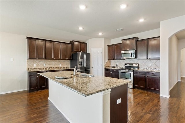 2820 Keathley Dr, Lorena, TX 76655 - kitchen featuring dark wood-style floors, a kitchen island with sink, a sink, dark brown cabinetry, and appliances with stainless steel finishes