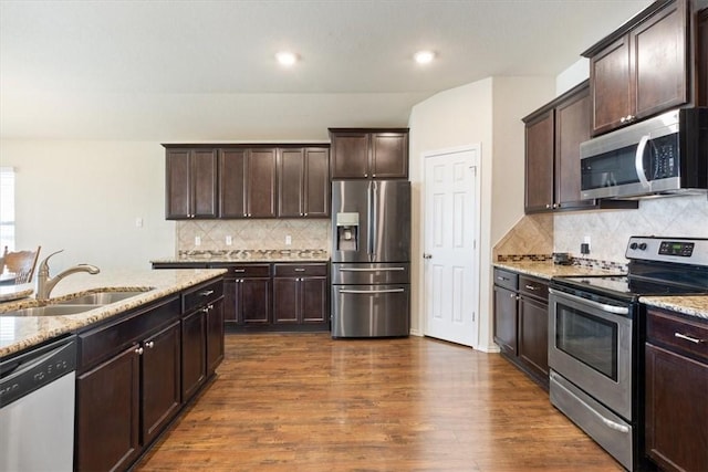 2820 Keathley Dr, Lorena, TX 76655 - kitchen with light stone countertops, dark wood finished floors, a sink, stainless steel appliances, and dark brown cabinets