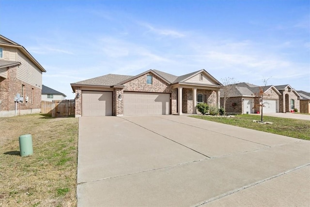 2820 Keathley Dr, Lorena, TX 76655 - view of front of property featuring a front lawn, fence, concrete driveway, a garage, and brick siding