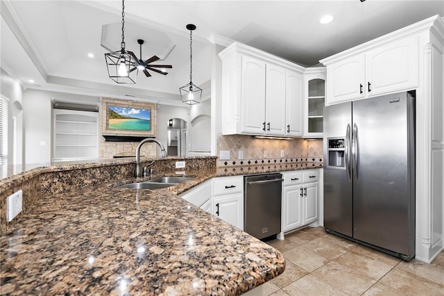 3243 N Lone Star Pkwy, Mcgregor, TX 76657 - kitchen with dark stone counters, arched walkways, a sink, appliances with stainless steel finishes, and crown molding