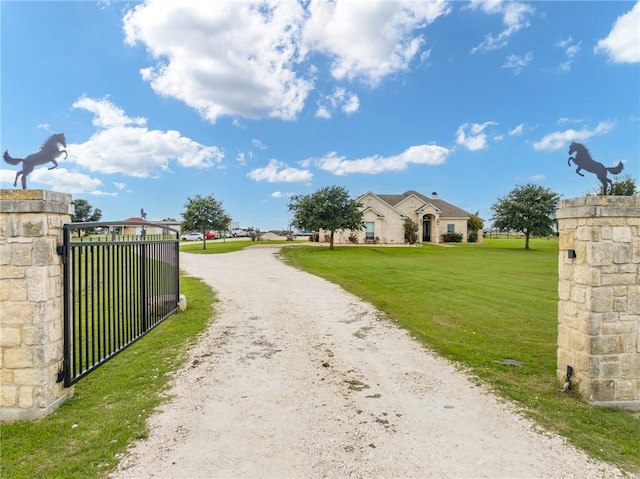 3243 N Lone Star Pkwy, Mcgregor, TX 76657 - view of road with a gate, dirt driveway, and a gated entry