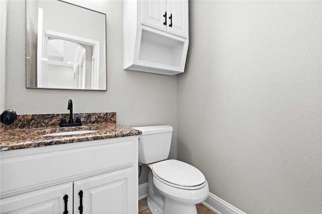 3243 N Lone Star Pkwy, Mcgregor, TX 76657 - half bathroom featuring toilet, vanity, and baseboards
