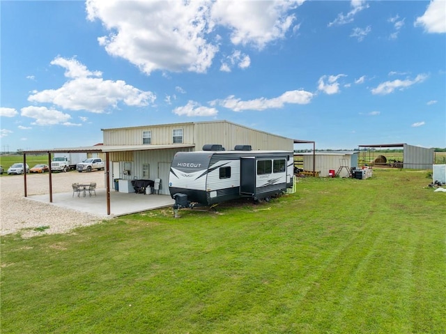 3243 N Lone Star Pkwy, Mcgregor, TX 76657 - rear view of house featuring an outdoor structure and a yard