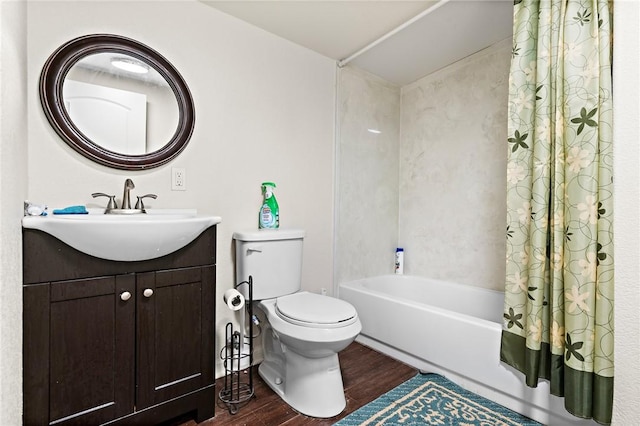 3243 N Lone Star Pkwy, Mcgregor, TX 76657 - bathroom with vanity, toilet, shower / tub combo with curtain, and wood finished floors
