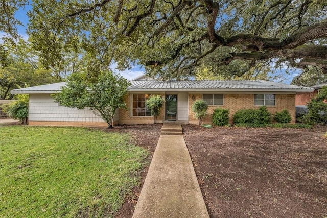 single story home featuring brick siding and a front lawn