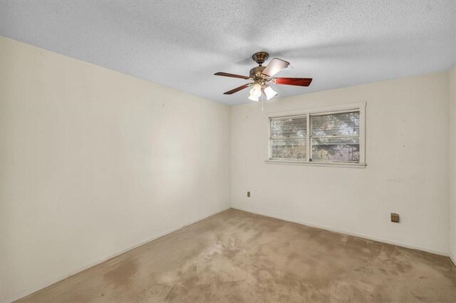 empty room featuring carpet flooring, a ceiling fan, and a textured ceiling