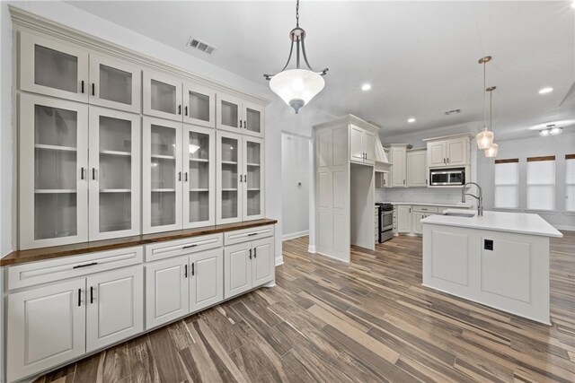 3103 Park Lake Dr, Waco, TX 76708 - clothes washing area with cabinet space, dark wood-style flooring, hookup for a washing machine, baseboards, and hookup for an electric dryer