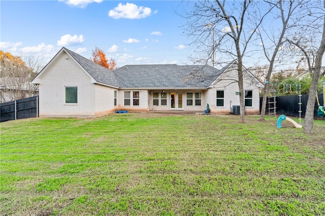 3103 Park Lake Dr, Waco, TX 76708 - back of house featuring fence, brick siding, central AC unit, a shingled roof, and a yard