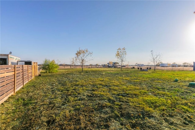 view of yard with a rural view and fence