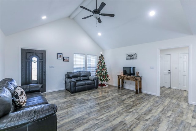 living room featuring beamed ceiling, high vaulted ceiling, a ceiling fan, and wood finished floors