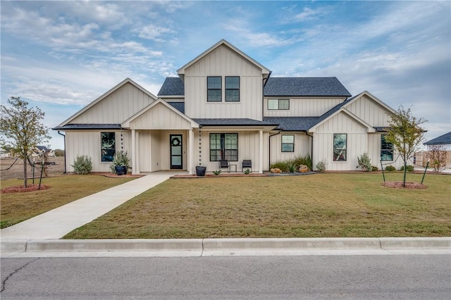modern farmhouse style home featuring board and batten siding, a front yard, and a shingled roof