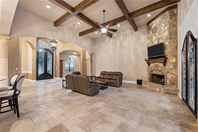 8460 Spicewood Springs Rd, China Spring, TX 76633 - living area featuring ceiling fan, a stone fireplace, arched walkways, coffered ceiling, and ornate columns