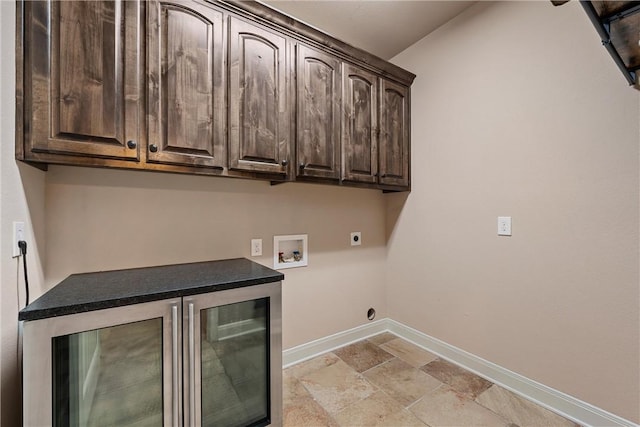 8460 Spicewood Springs Rd, China Spring, TX 76633 - laundry area featuring hookup for a washing machine, baseboards, hookup for an electric dryer, cabinet space, and stone tile flooring