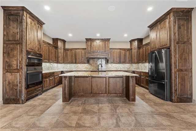 8460 Spicewood Springs Rd, China Spring, TX 76633 - kitchen with fridge with ice dispenser, a center island with sink, backsplash, and a sink