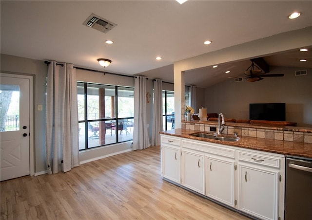 kitchen featuring visible vents, white cabinets, dishwasher, and a sink