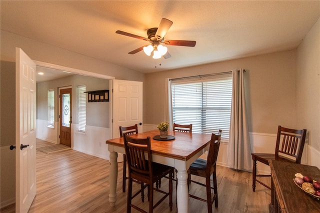 dining room with plenty of natural light, light wood-style flooring, and a ceiling fan