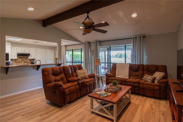 living area with baseboards, lofted ceiling with beams, light wood-style flooring, recessed lighting, and ceiling fan