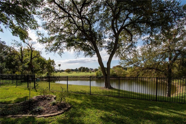 exterior space featuring fence and a water view