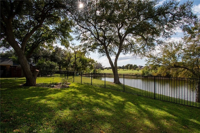 view of yard featuring fence and a water view