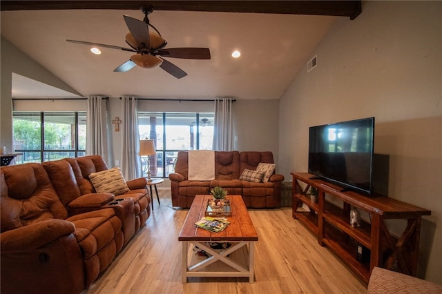 living room featuring light wood-style flooring, vaulted ceiling with beams, a ceiling fan, and visible vents