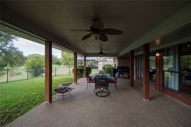 view of patio / terrace featuring a ceiling fan, fence, and a fire pit