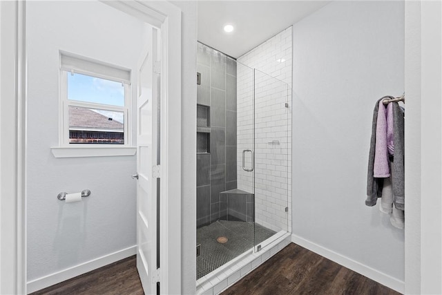 bathroom featuring recessed lighting, a shower stall, baseboards, and wood finished floors