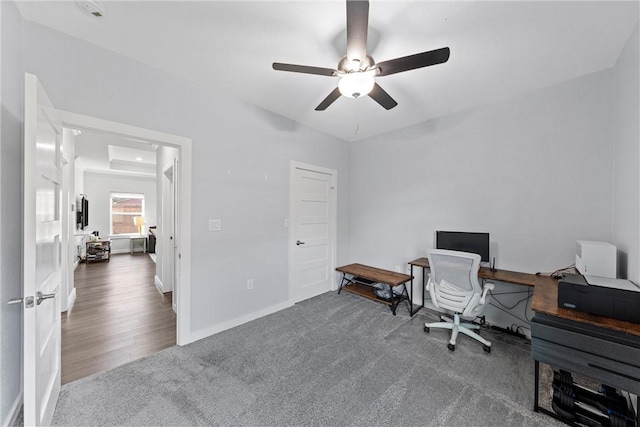 office space with baseboards, ceiling fan, and carpet floors