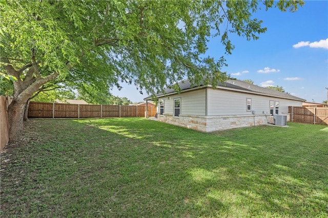 view of yard with central AC unit and a fenced backyard