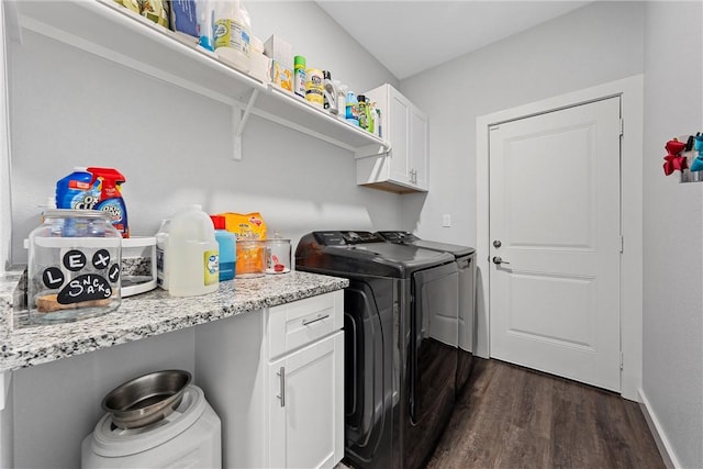 clothes washing area featuring dark wood-style flooring, cabinet space, baseboards, and separate washer and dryer