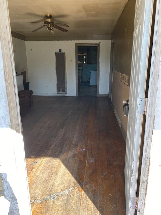unfurnished living room featuring baseboards, ceiling fan, and hardwood / wood-style flooring