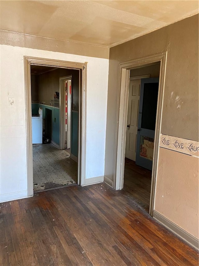 spare room featuring baseboards and hardwood / wood-style flooring